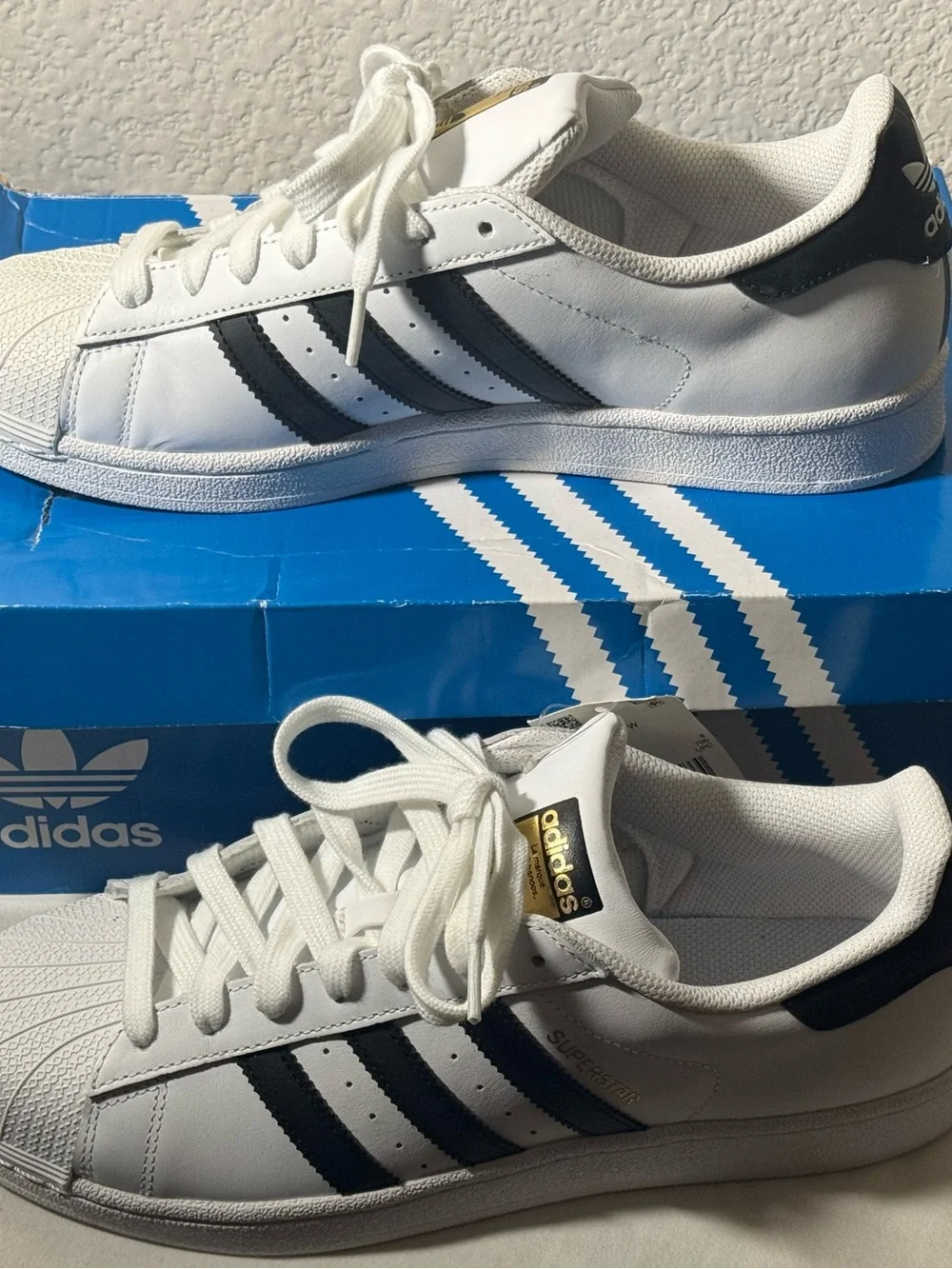 Adidas Superstar Sneakers with Black Stripes and Gold Tongue Logo